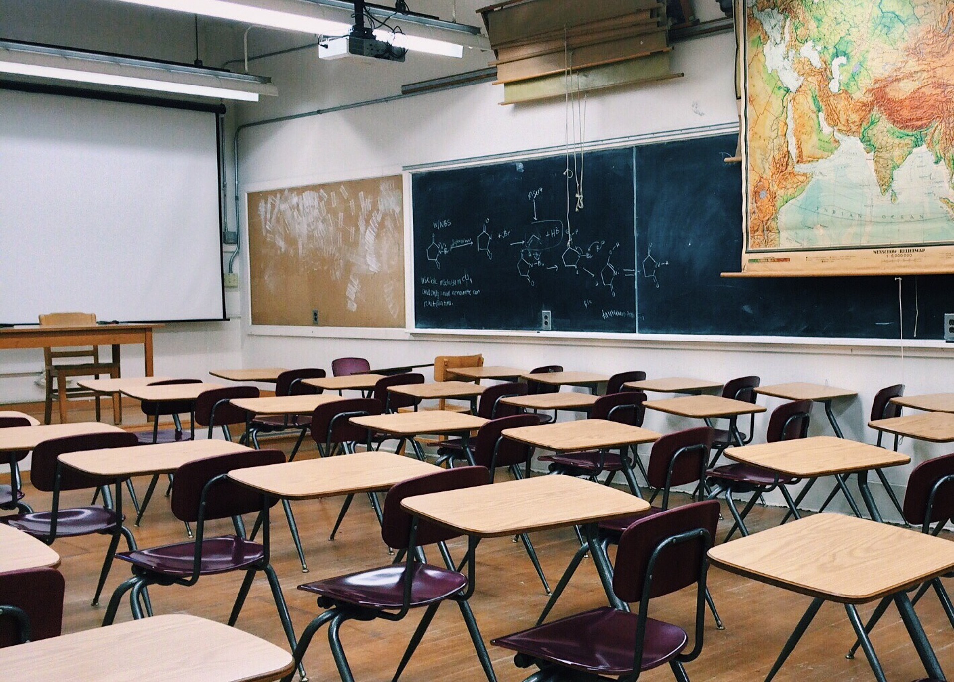 Empty classroom with desks and blackboards.